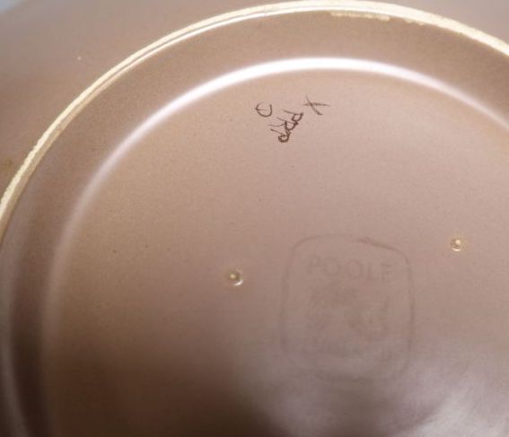 A Poole Pottery wall plate, initialled verso PRP, 33cm